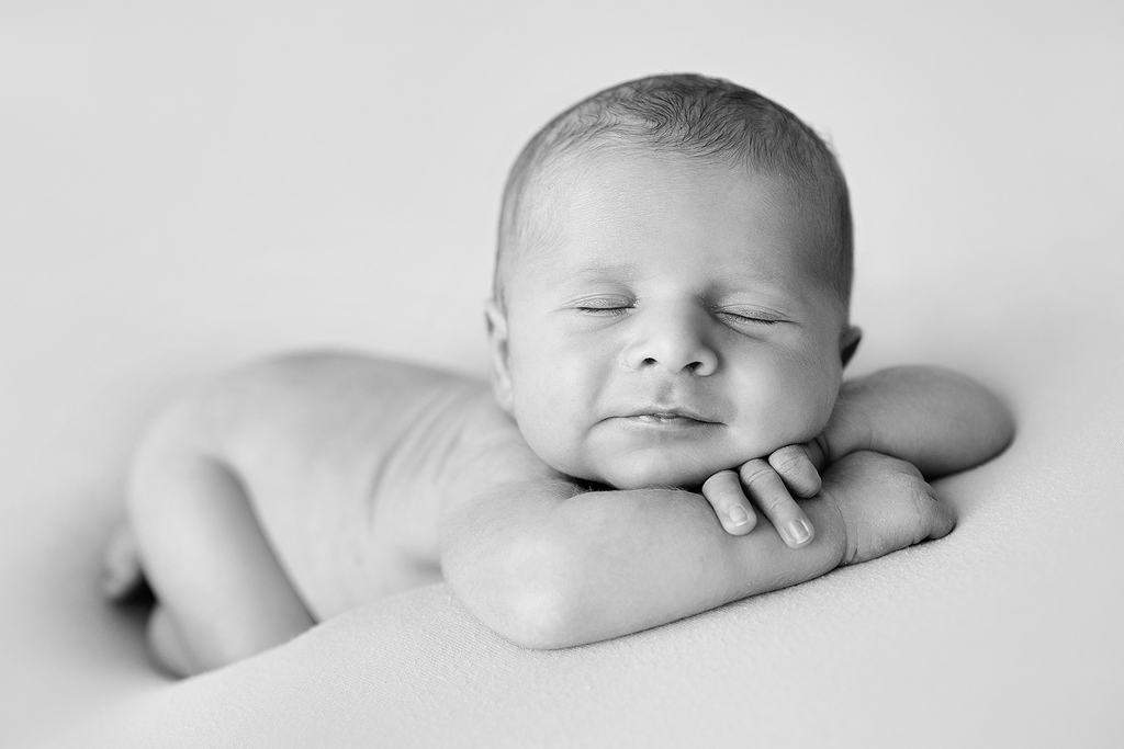 little baby smiling while asleep - professional newborn photography by Kelly McCambley