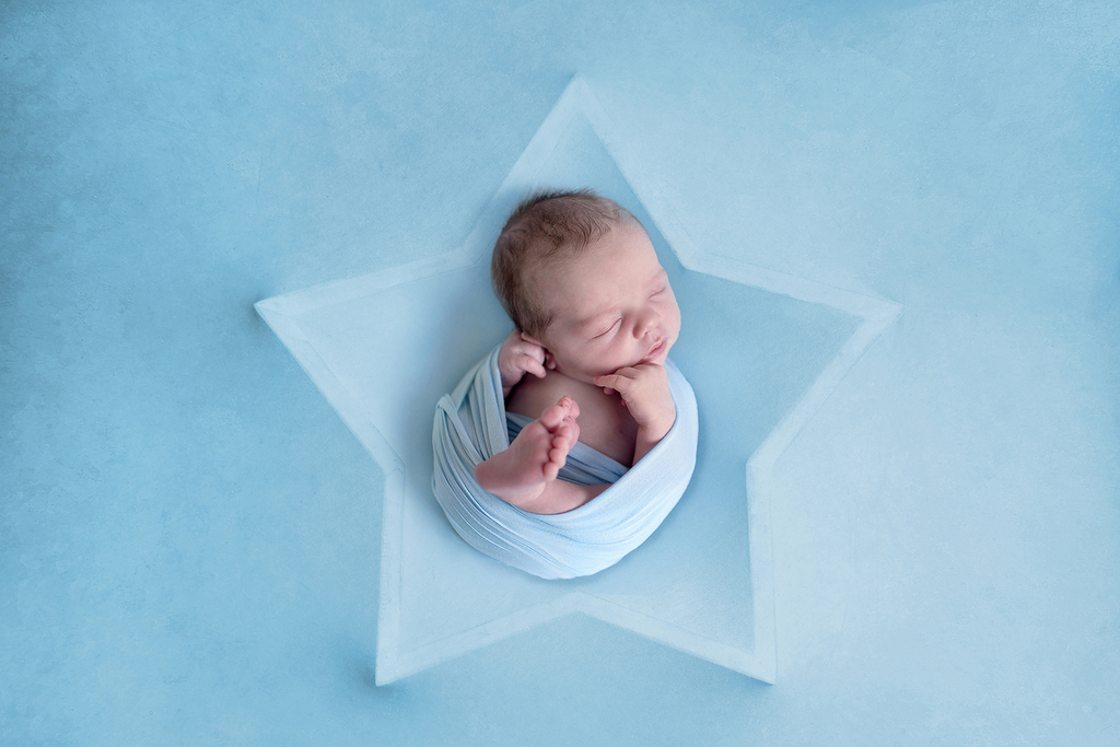 star shaped background with newborn baby on