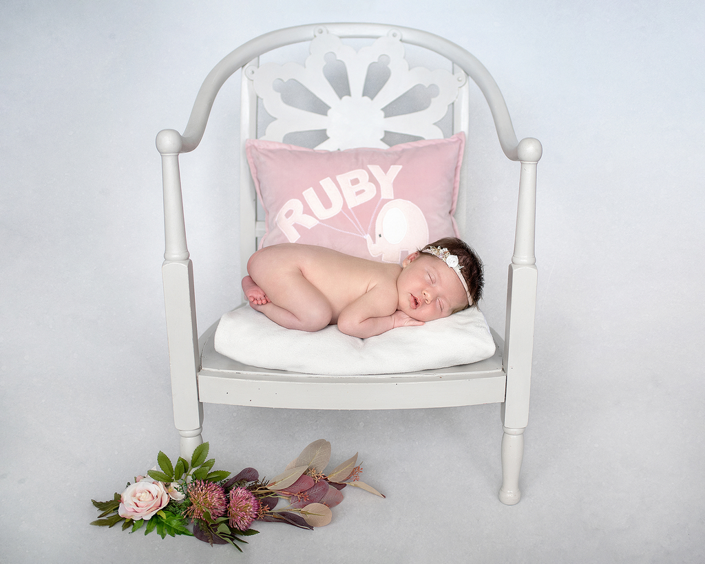 Newborn baby asleep on a chair professional Northern Ireland photoshoot
